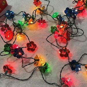 Flower shaped multi colored lights with reflectors in original box.